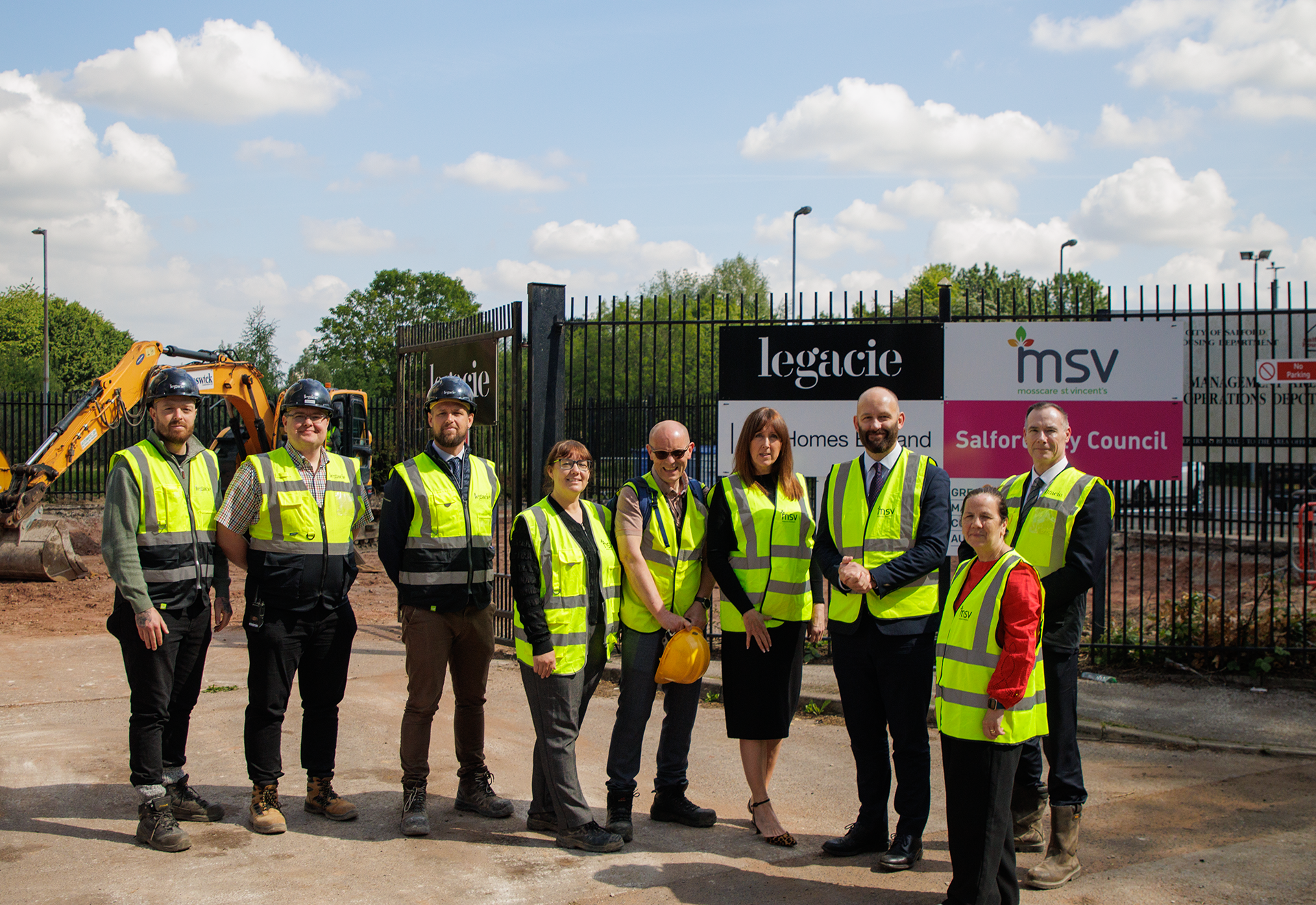 City Mayor Paul Dennett and Councillor Kelly stood with a group of people in front of a construction site