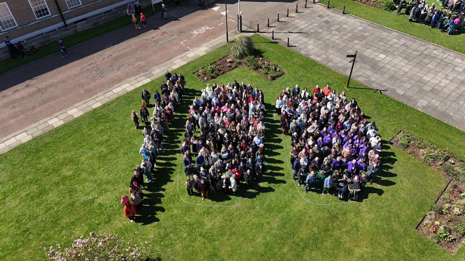 Salford 100 people together on civic lawn