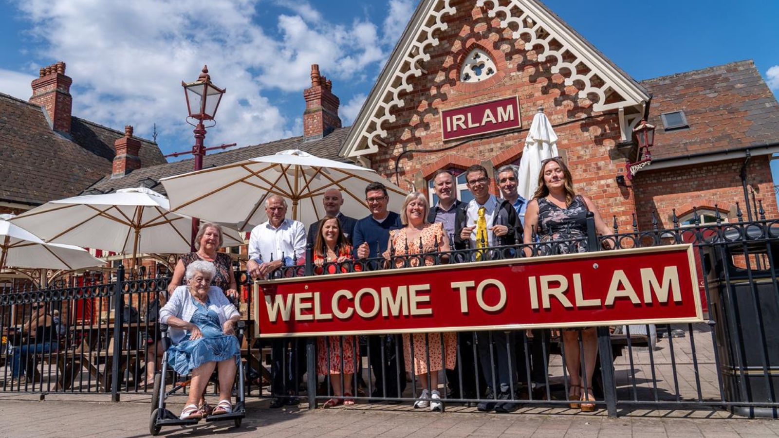 Andy Burnham and others stood outside of Irlam train station