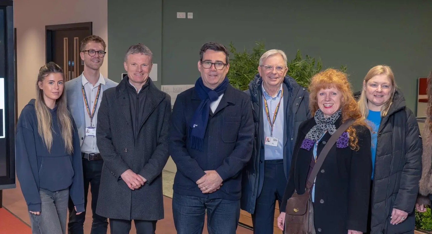 A group of people stood smiling