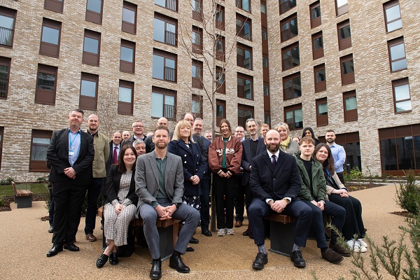 Greenhaus team sat and stood together by a building
