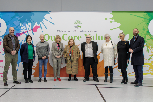 City Mayor stood with a group of councillors and staff in front of wall mural