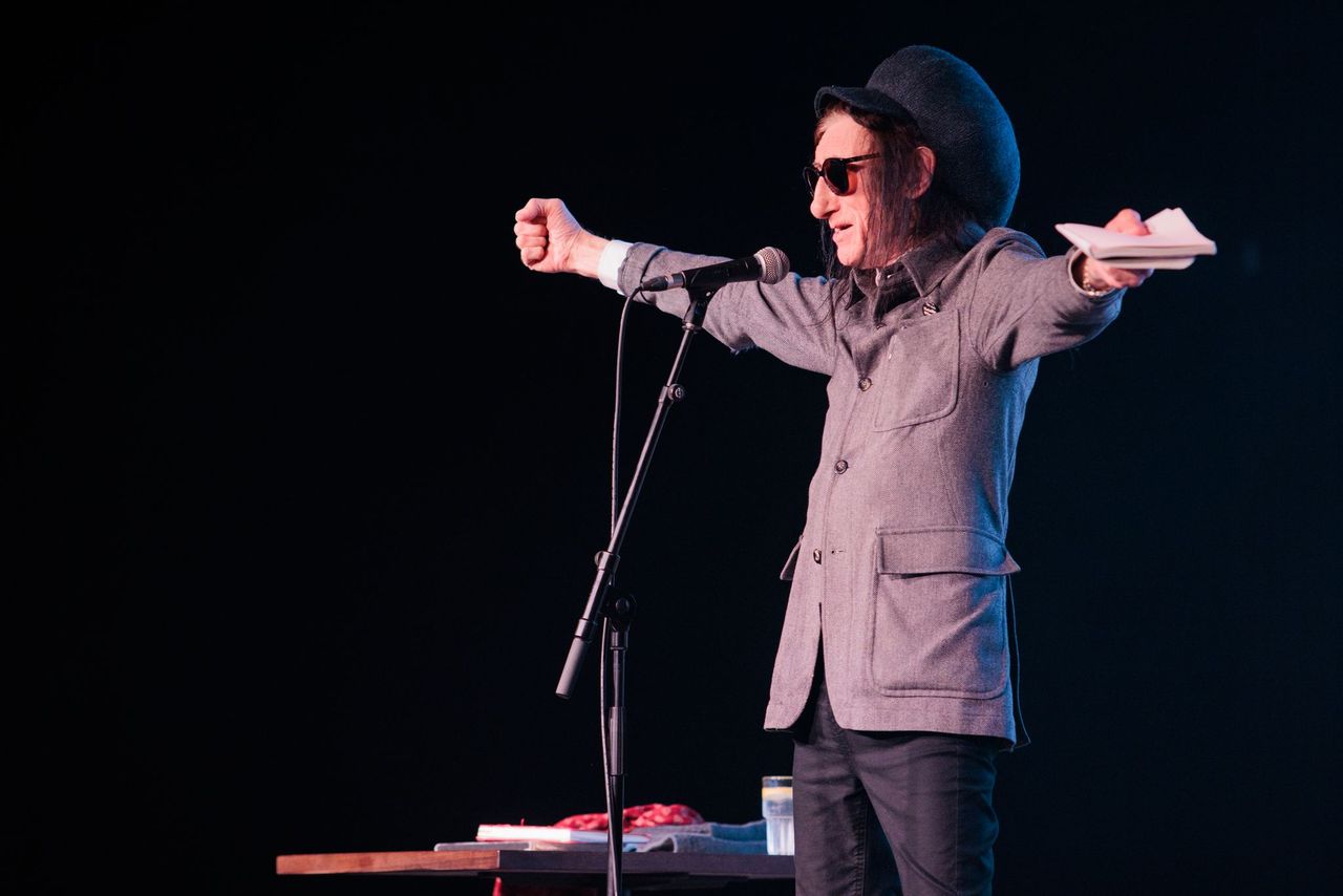 John Cooper Clarke performing on stage