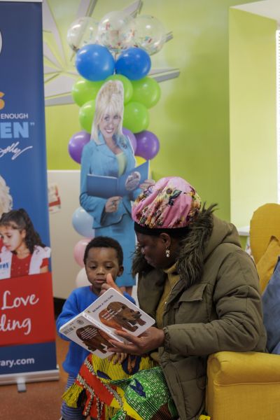Mum Juliet Agiye reading a book with son Asima