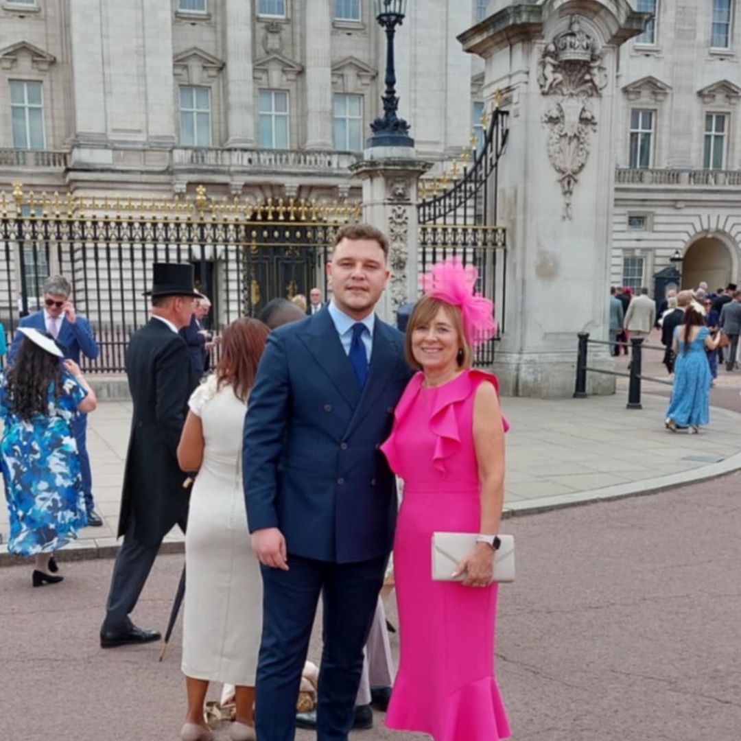 Woman and son at King Charles' garden party outside Buckingham Palace