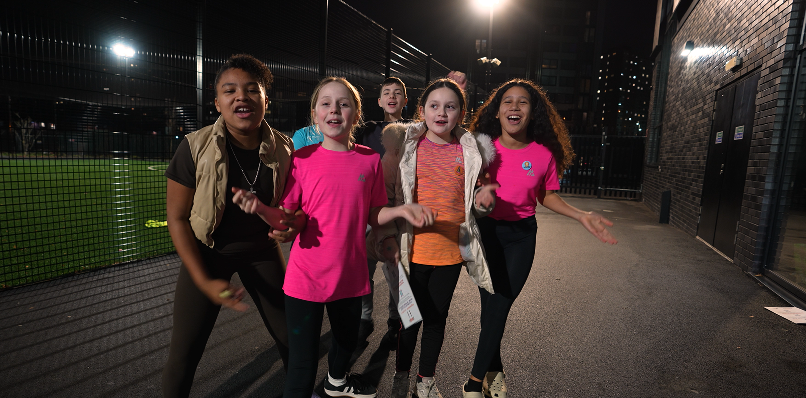 A group of children are smiling and cheering
