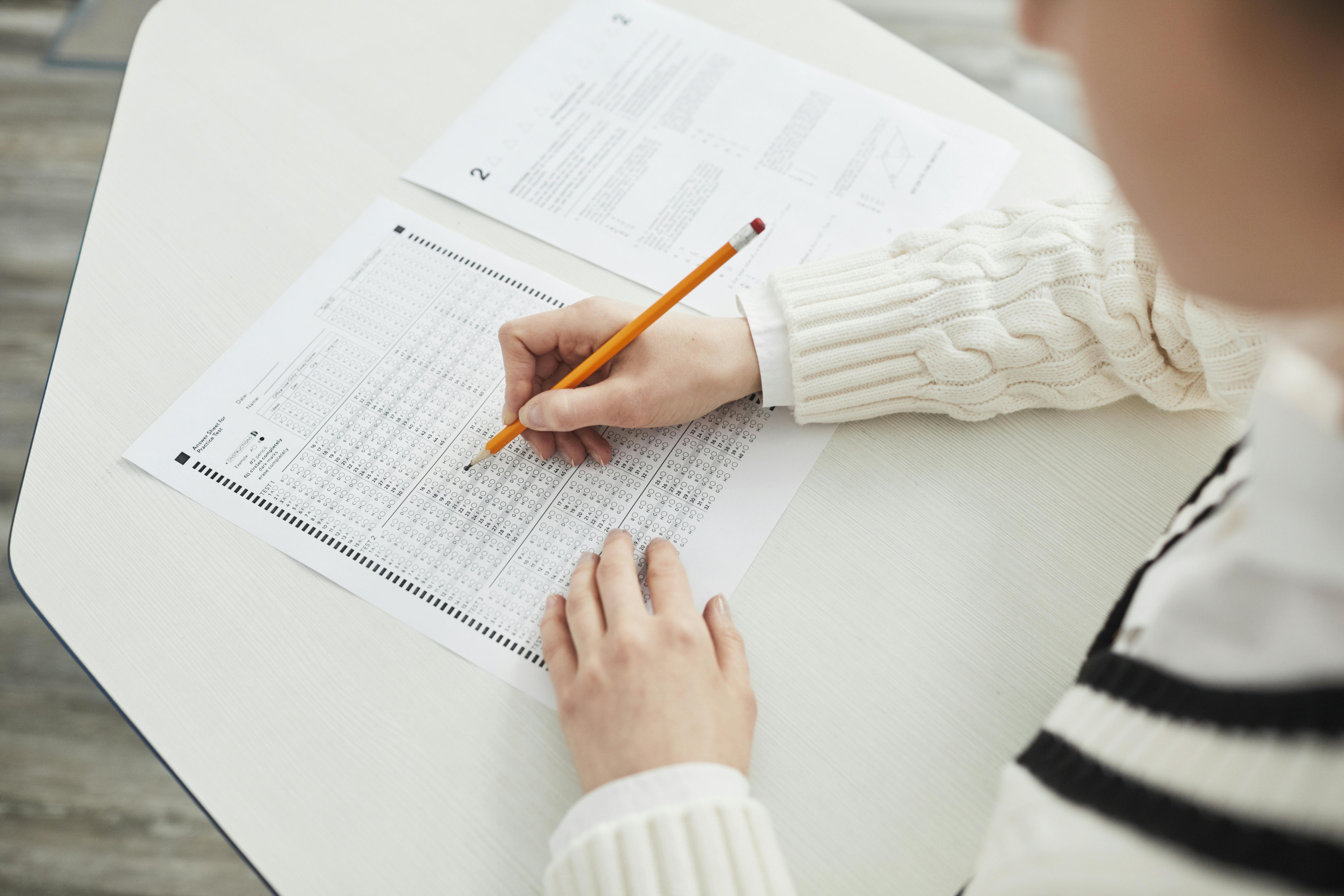 School pupil sitting at a desk doing school work