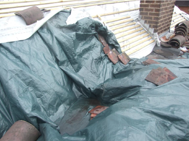 Close-up of tarpaulin covering bare roof