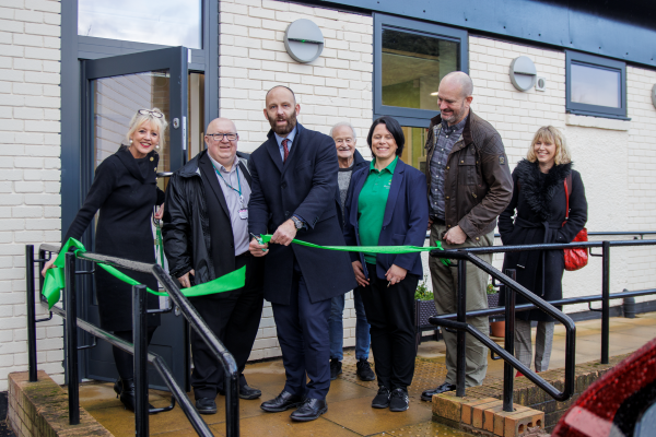 City Mayor cutting ribbon to new unit, with councillors and staff